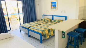 A room with a bed, a desk, and a chair.
