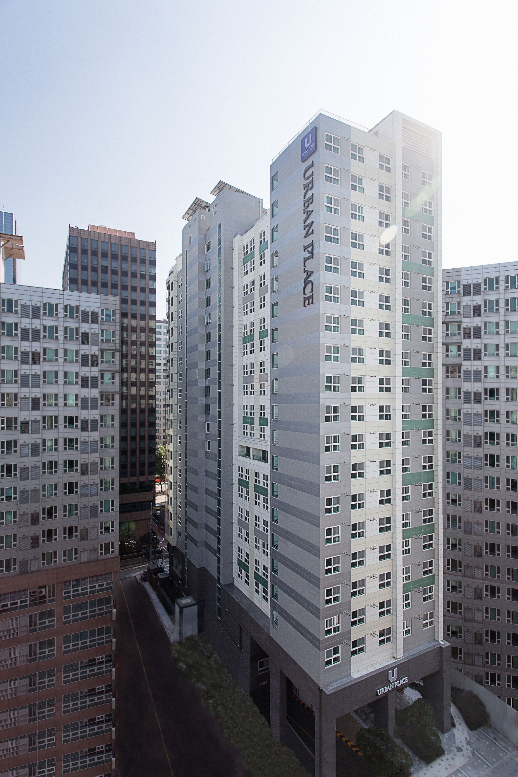 A high-rise building with multiple floors, featuring a prominent "URBAN PLACE" sign.