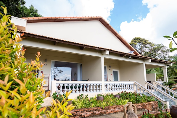 A two-story building with a white facade, a red-tiled roof, and a balcony with a white balustrade. - Sea Sense Resort (Phu Quoc)
