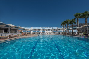 Piscine extérieure, parasols de plage, chaises longues