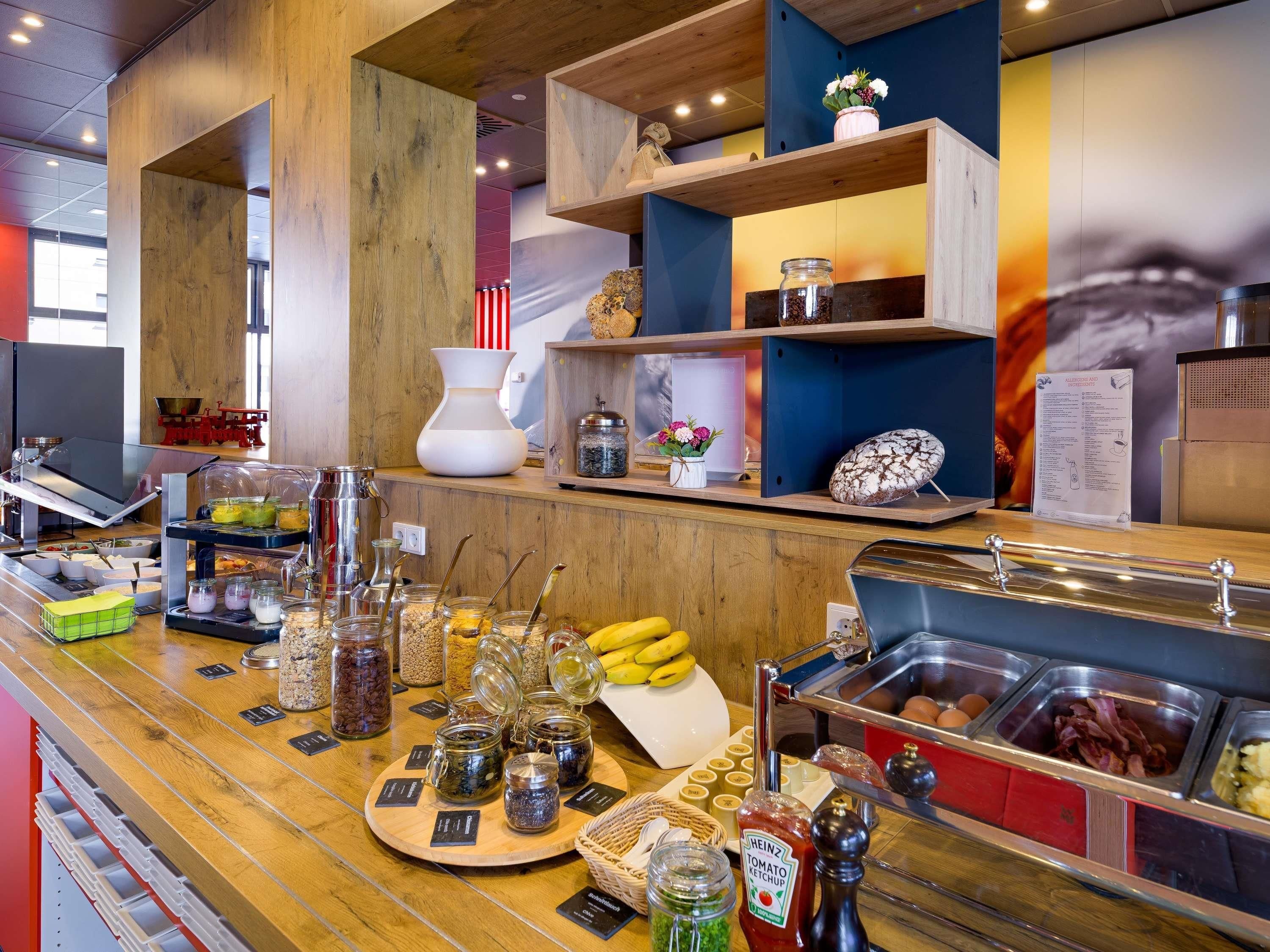 A breakfast buffet with various food items and condiments.
