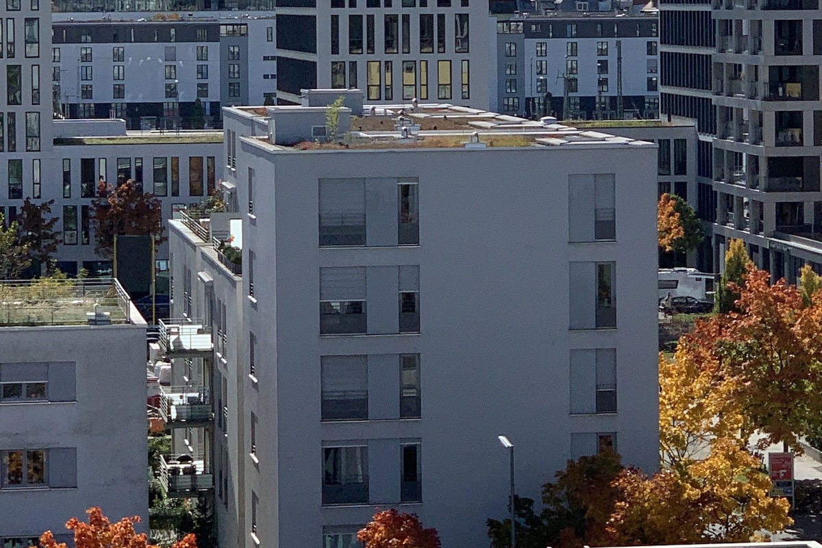 A modern urban building with multiple floors, large windows, and a flat roof.