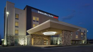 A modern hotel with a stone facade, a prominent marquee sign, and a covered entrance area. - SpringHill Suites Bridgeport Clarksburg (Bridgeport)
