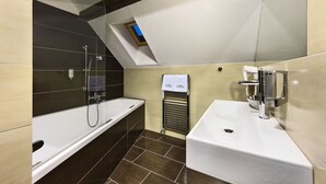 Un baño moderno con bañera, lavabo y ducha.