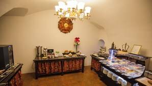 A buffet area with a variety of food options, a coffee station, and a decorative wall piece. - Depandance Edward Kelly (Cesky Krumlov)