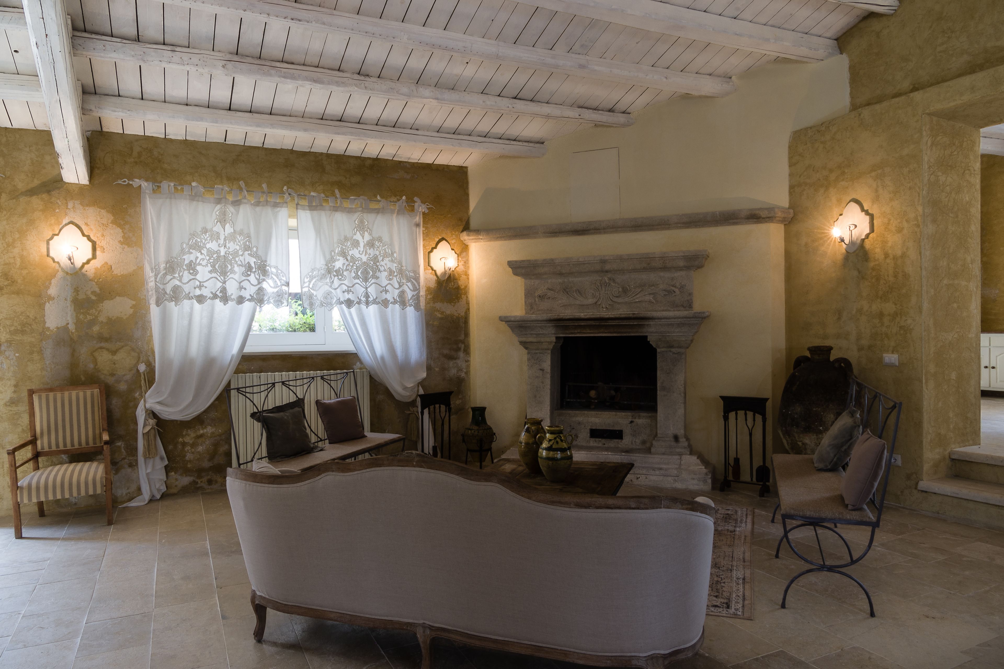 Une pièce chaleureuse avec une cheminée, un canapé et deux fauteuils.
