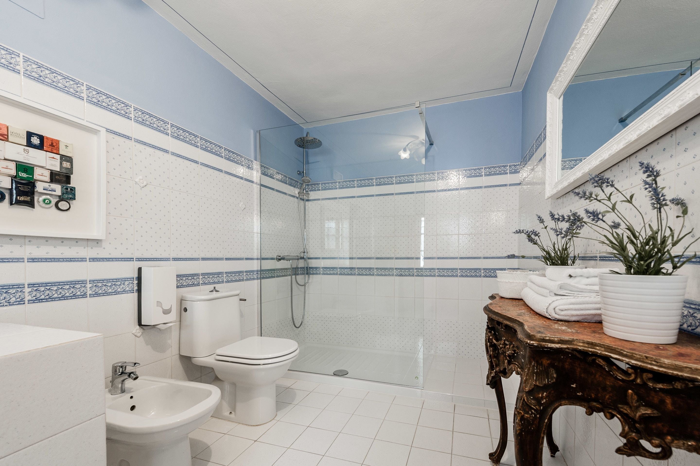 A bathroom with a toilet, bidet, and shower.