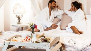 Enjoy a warm and inviting bedroom with a plush bed, breakfast tray, and elegant vase.