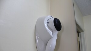 A white hair dryer mounted on a wall. - Tourway Inn (Birmingham)