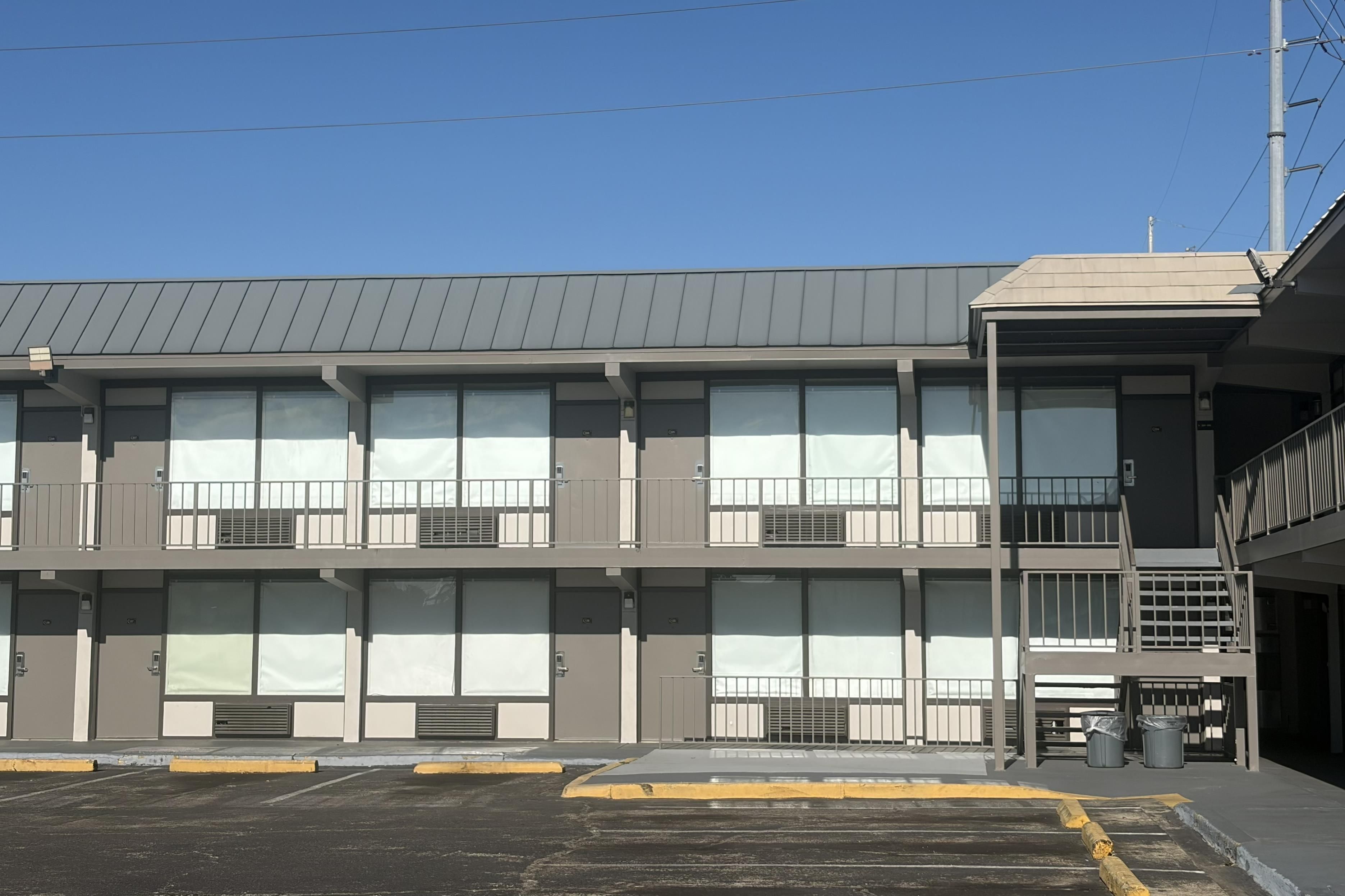 A multi-story building with large windows and a flat roof.