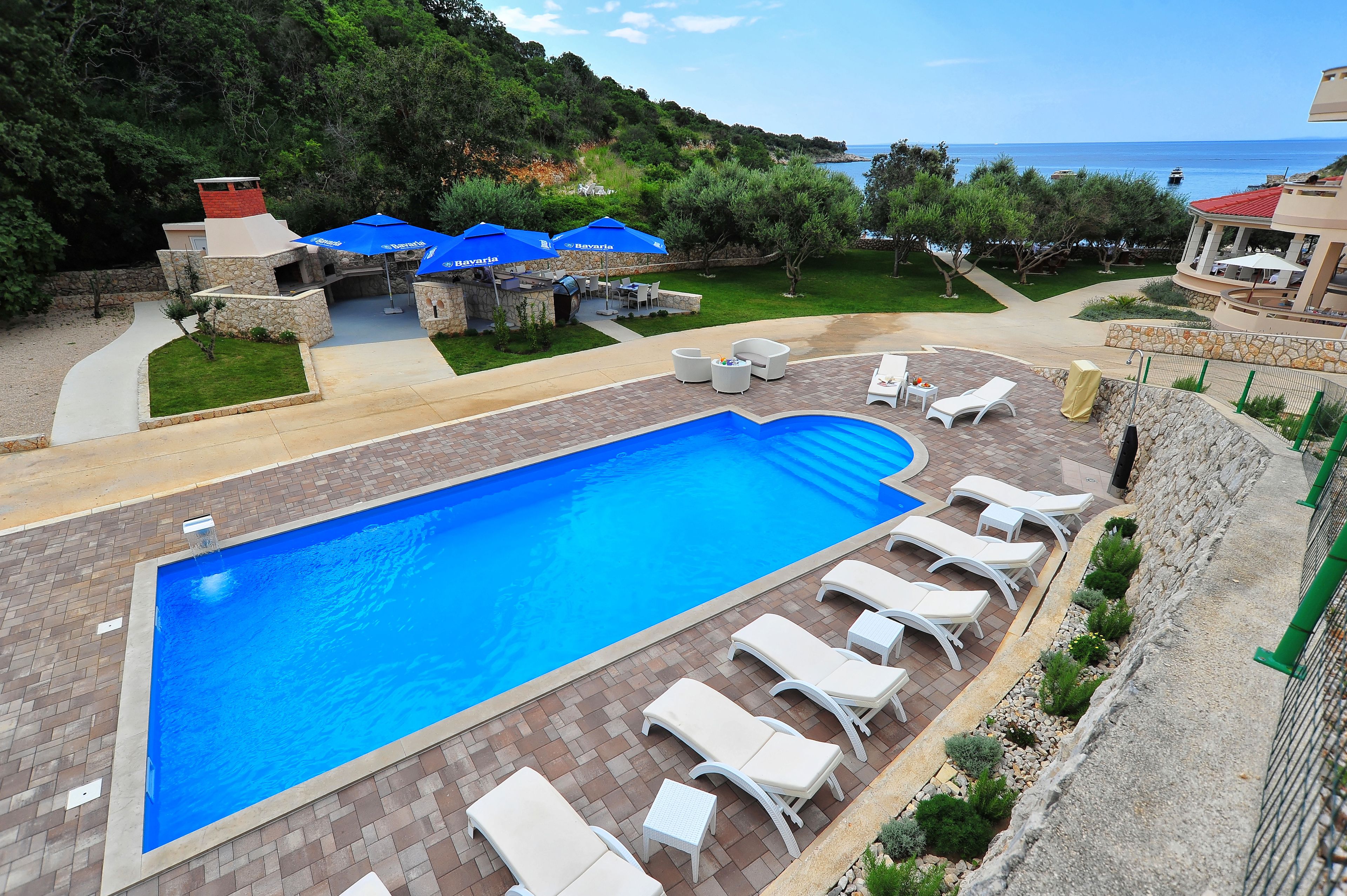 Seasonal outdoor pool, a waterfall pool, pool umbrellas, pool loungers