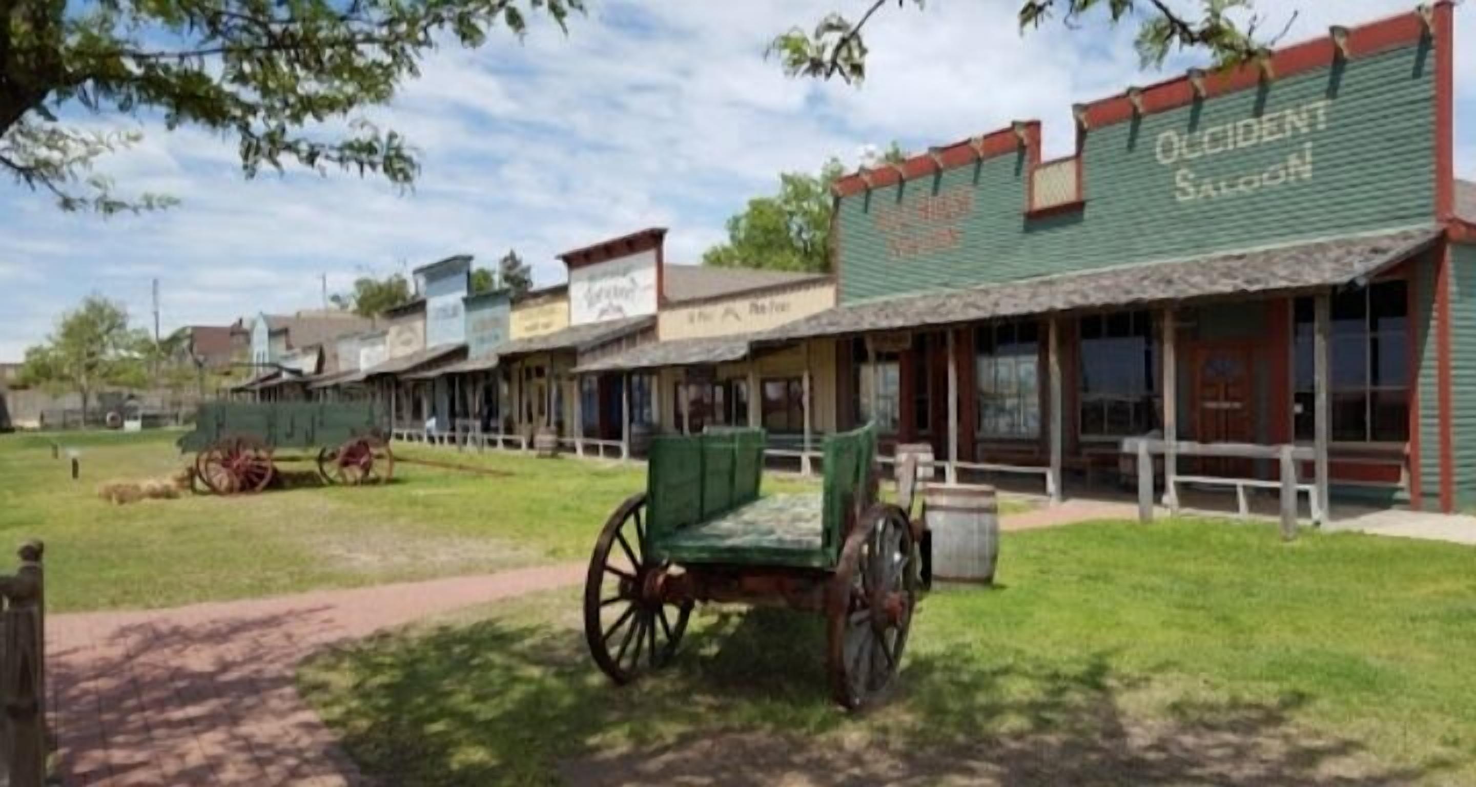 A historic building with a green facade and a sign that reads "Occident Saloon."