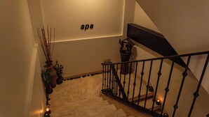 A staircase with a 'spa' sign on the wall, a potted plant, and a caution sign. - Boracay Sands Hotel (Boracay Island)