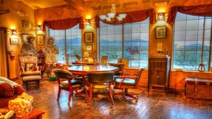 A room with a large window, a poker table, and various chairs. - Stagecoach Trails Guest Ranch (Yucca)