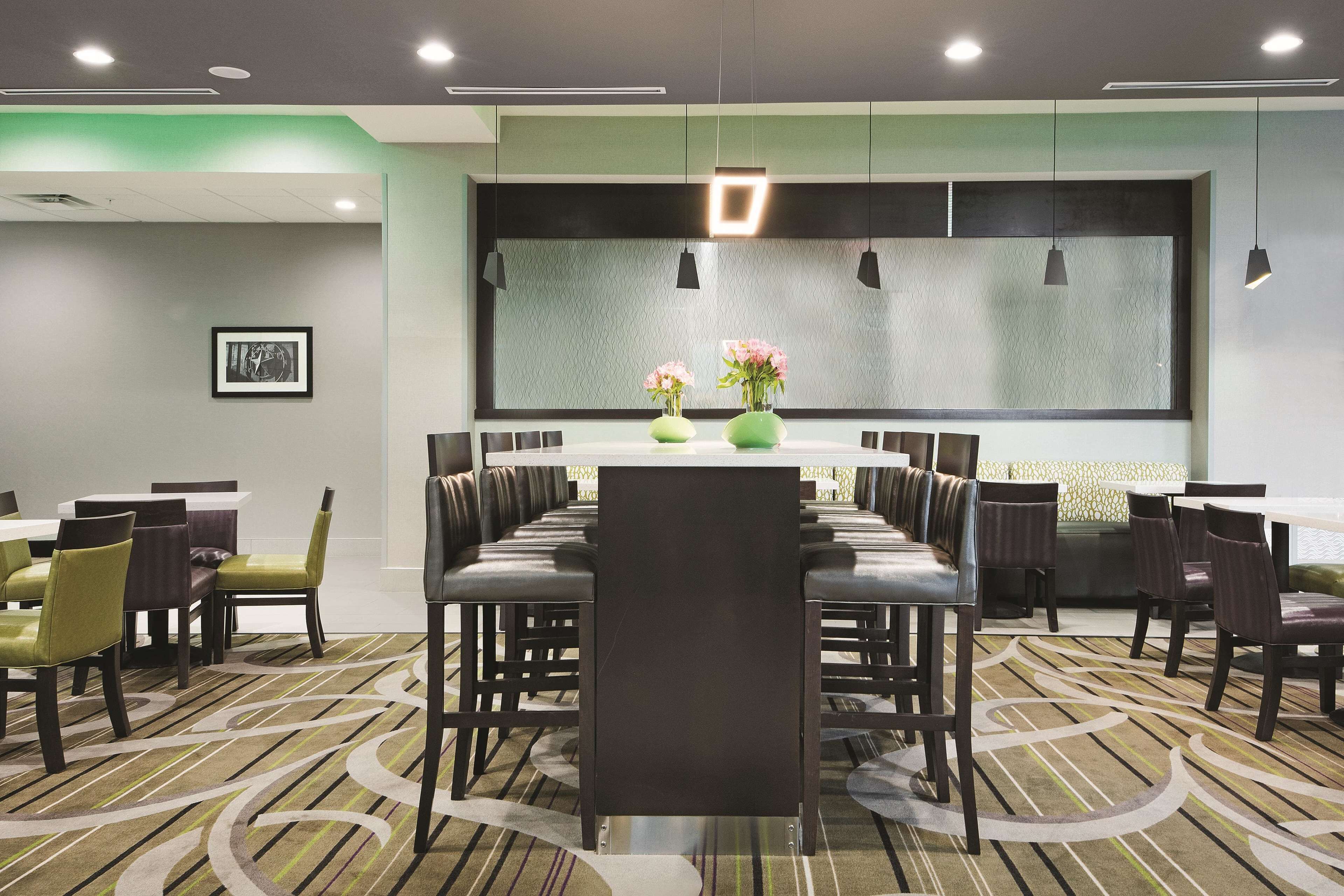 A conference room with a long table, chairs, and a large window.