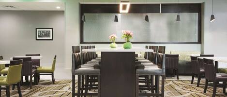 A conference room with a long table, chairs, and a large window.