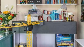 Work and play come together in this compact room with a desk area and shelves for leisure activities.