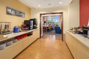 Enjoy a convenient self-service breakfast at our welcoming lobby area, featuring a dining space with tables and chairs.