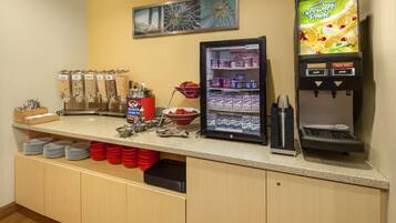 A breakfast bar with a coffee machine, cereal dispensers, and a refrigerated display.