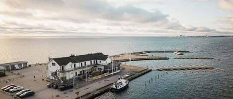 A coastal building with a dock and a boat.