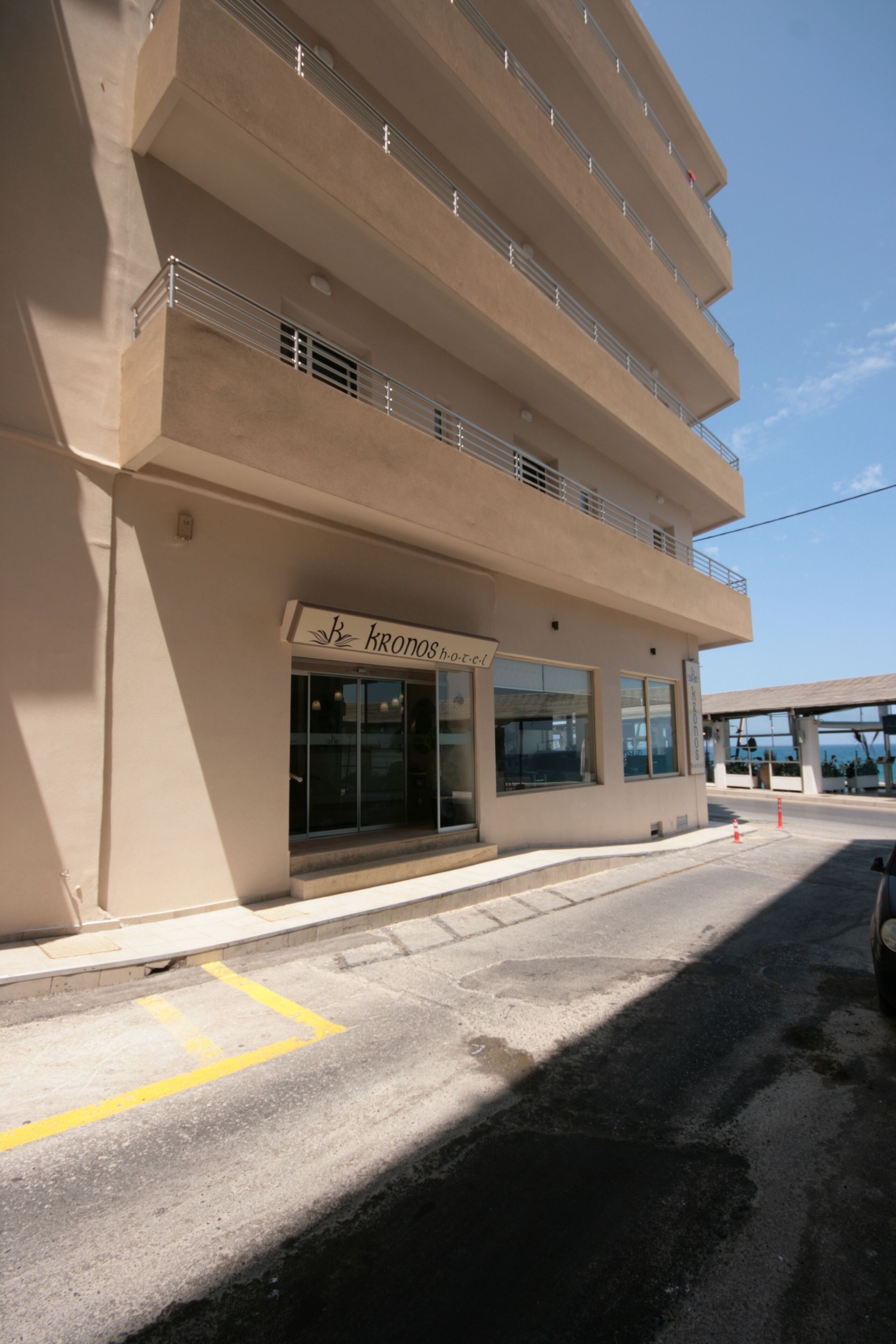 A multi-story hotel with a sign reading "KRONOS hotel".