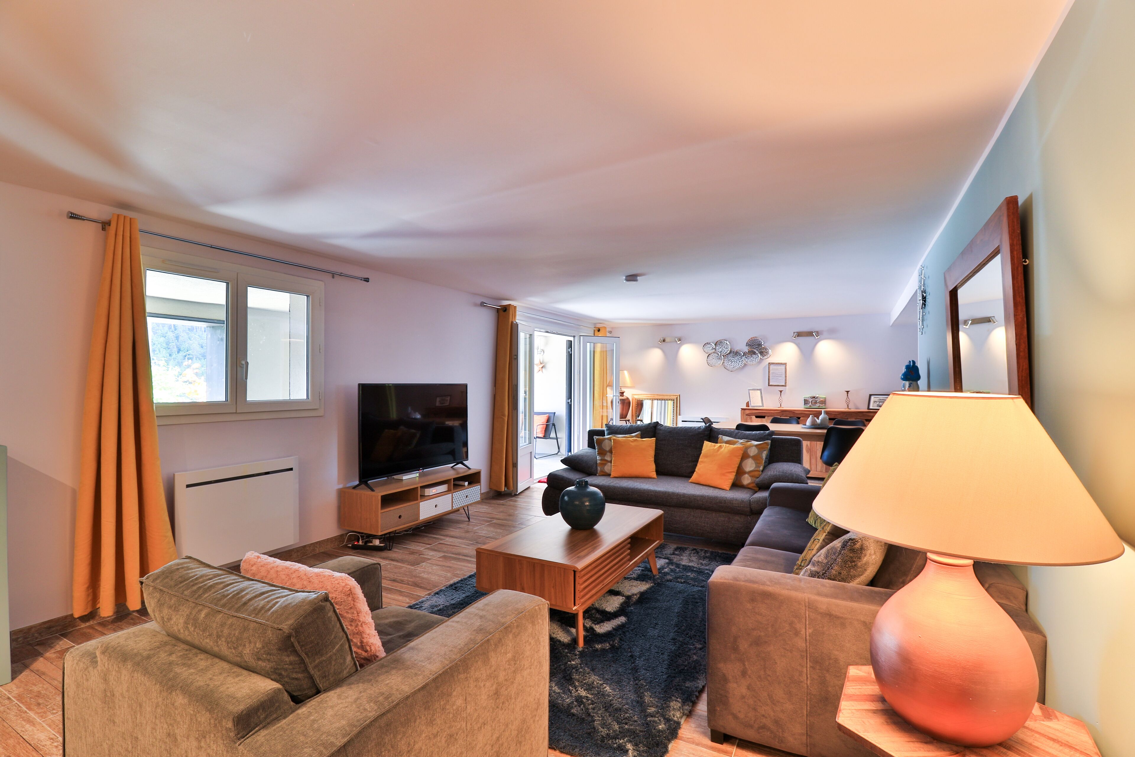 A modern living room with a sofa, coffee table, and TV.
