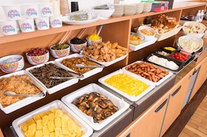 A buffet with various food items including fruits, vegetables, meats, and cheeses.