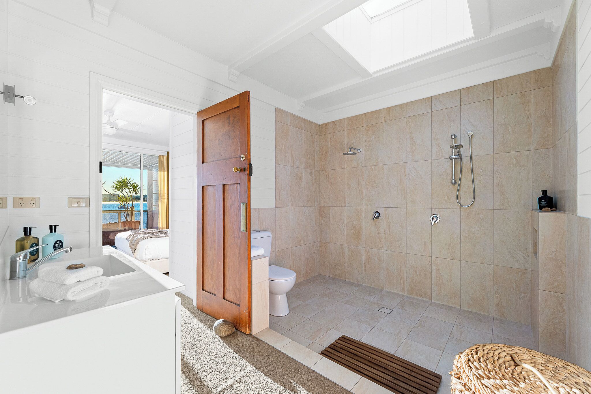 A bathroom with a shower, toilet, and sink.