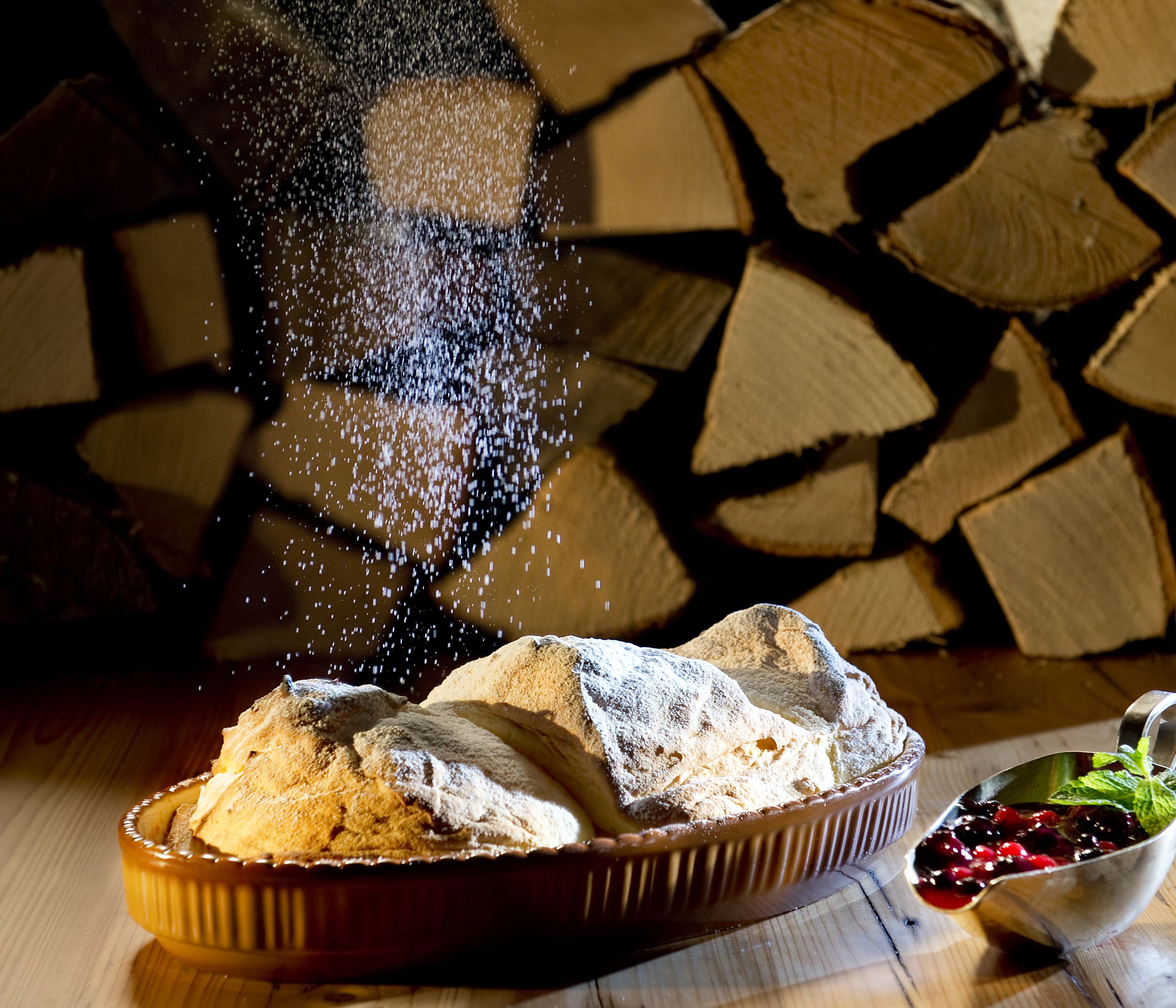 A dessert tray with a pastry and a bowl of berries.