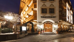 A hotel entrance with a sign reading "TIROLERHOF".
