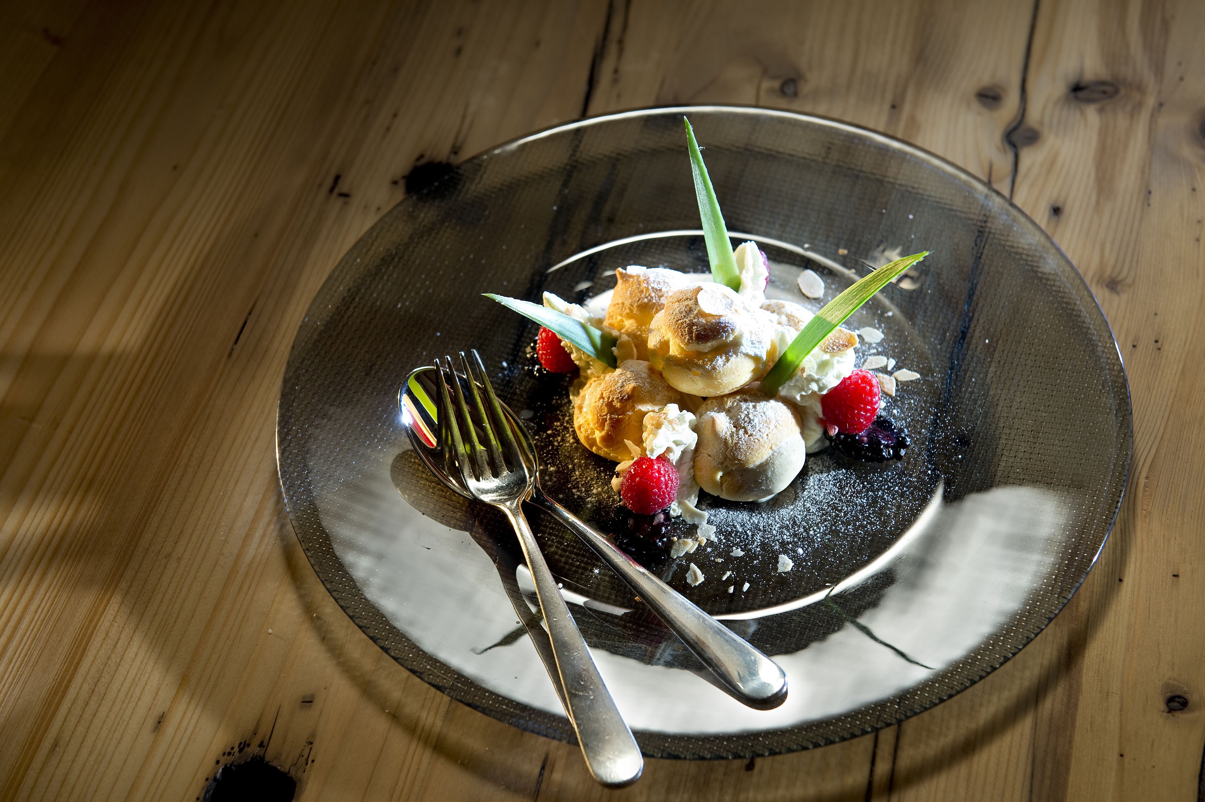A dessert on a plate with a fork and knife beside it.