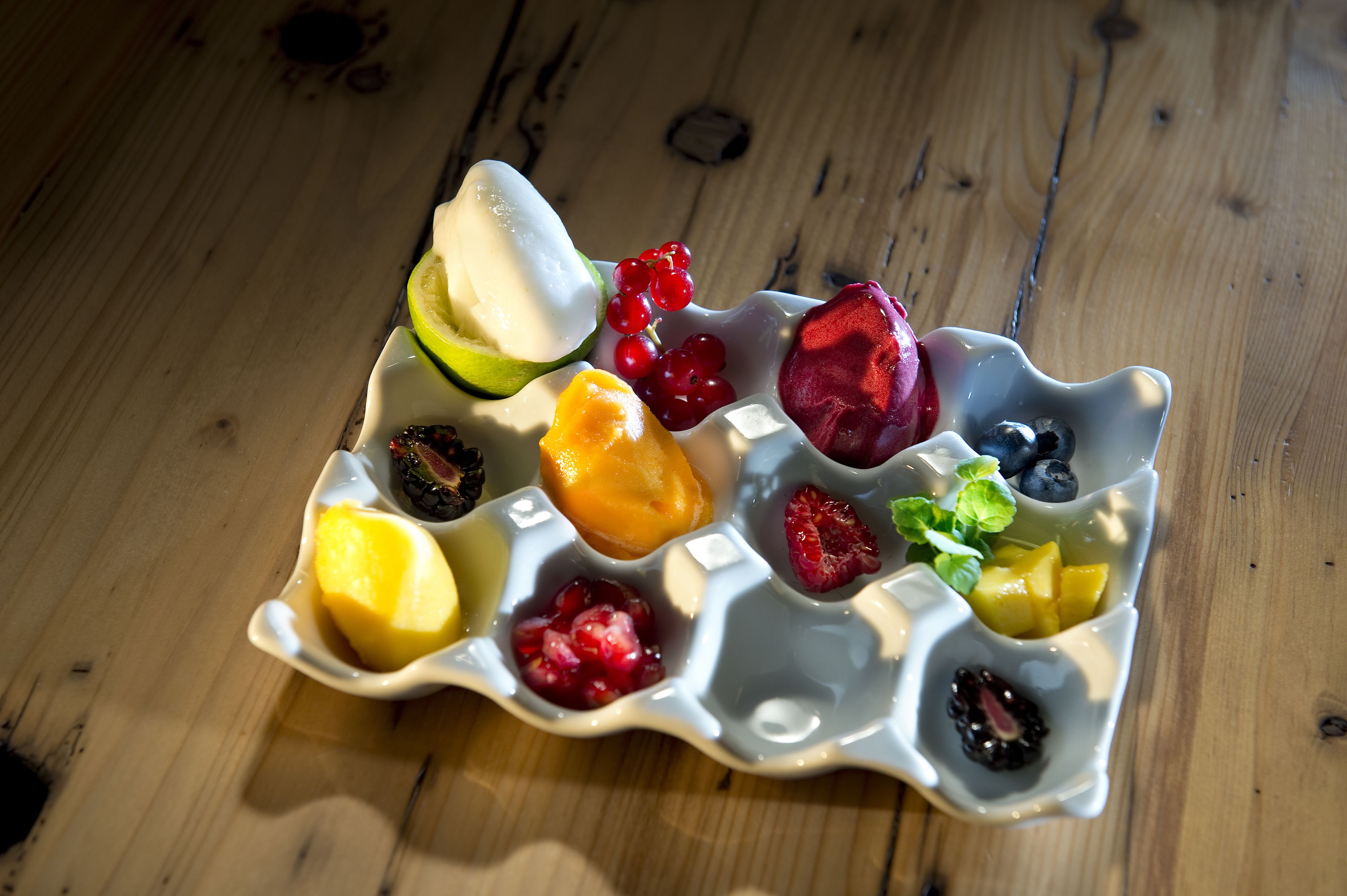 A fruit platter on a wooden table.