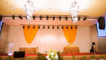 A stage with a podium, two tables, and a backdrop.