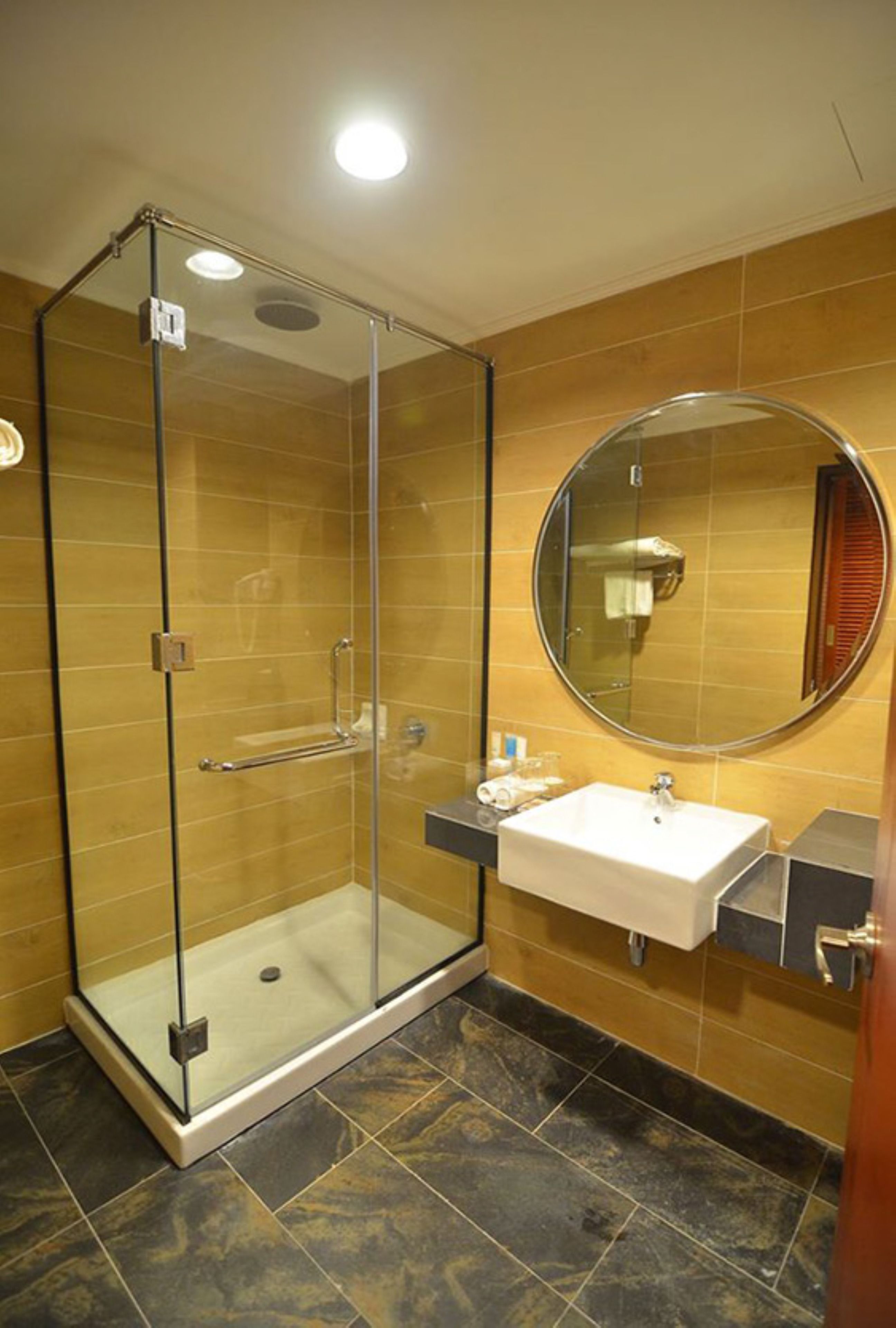 deluxe room | bathroom | rainfall showerhead, free toiletries, hair dryer, slippers