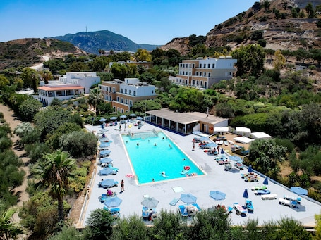 Outdoor pool, pool loungers. Hermes Hotel