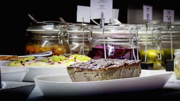A buffet with various food items and labels.