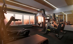Une salle de sport équipée de divers appareils d’exercice, dotée de grandes fenêtres et d’un design moderne au niveau du plafond.