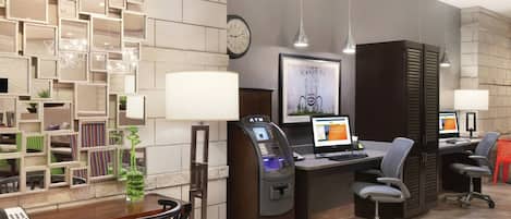 A modern office space with a desk, computer, and chair, a telephone, and a decorative wall with geometric patterns.