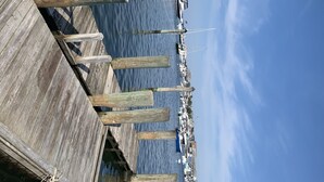 A wooden pier with boats docked in the background. - Madison Inn (Oak Bluffs)