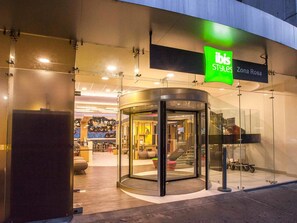 A modern storefront with a glass entrance, a green sign, and a visible interior with seating and a staircase. - ibis Styles Mexico Reforma (Mexico City)