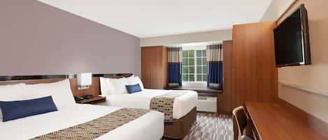 Premium bedding, pillow-top beds, desk, laptop workspace