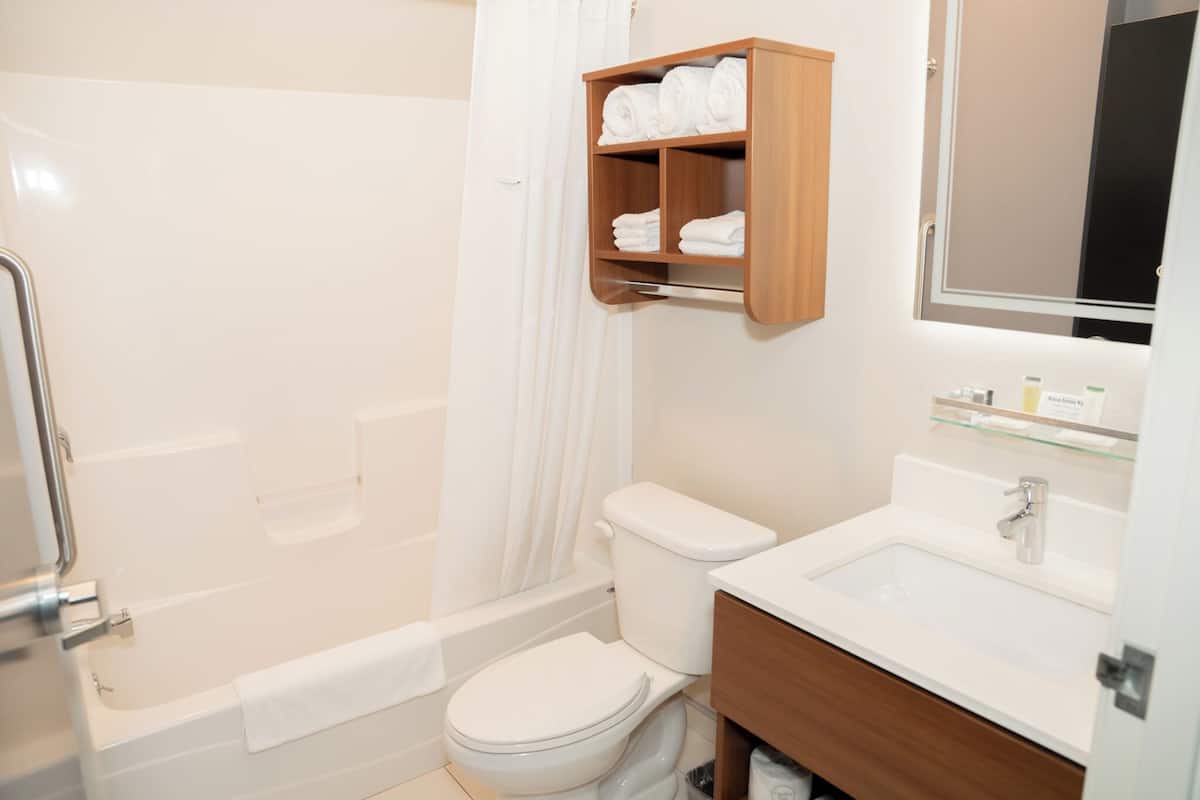 A bathroom with a bathtub, toilet, and sink.