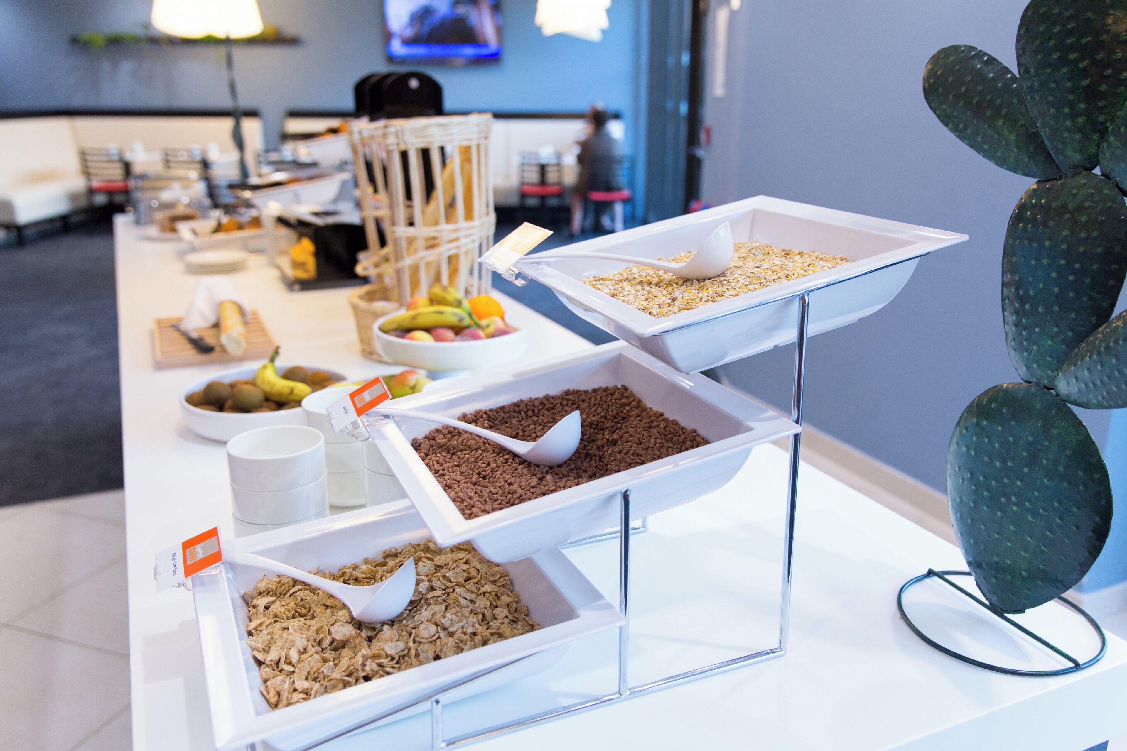 A buffet setup with various food items and utensils.