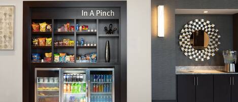 A vending machine labeled "In A Pinch" with snacks and drinks.