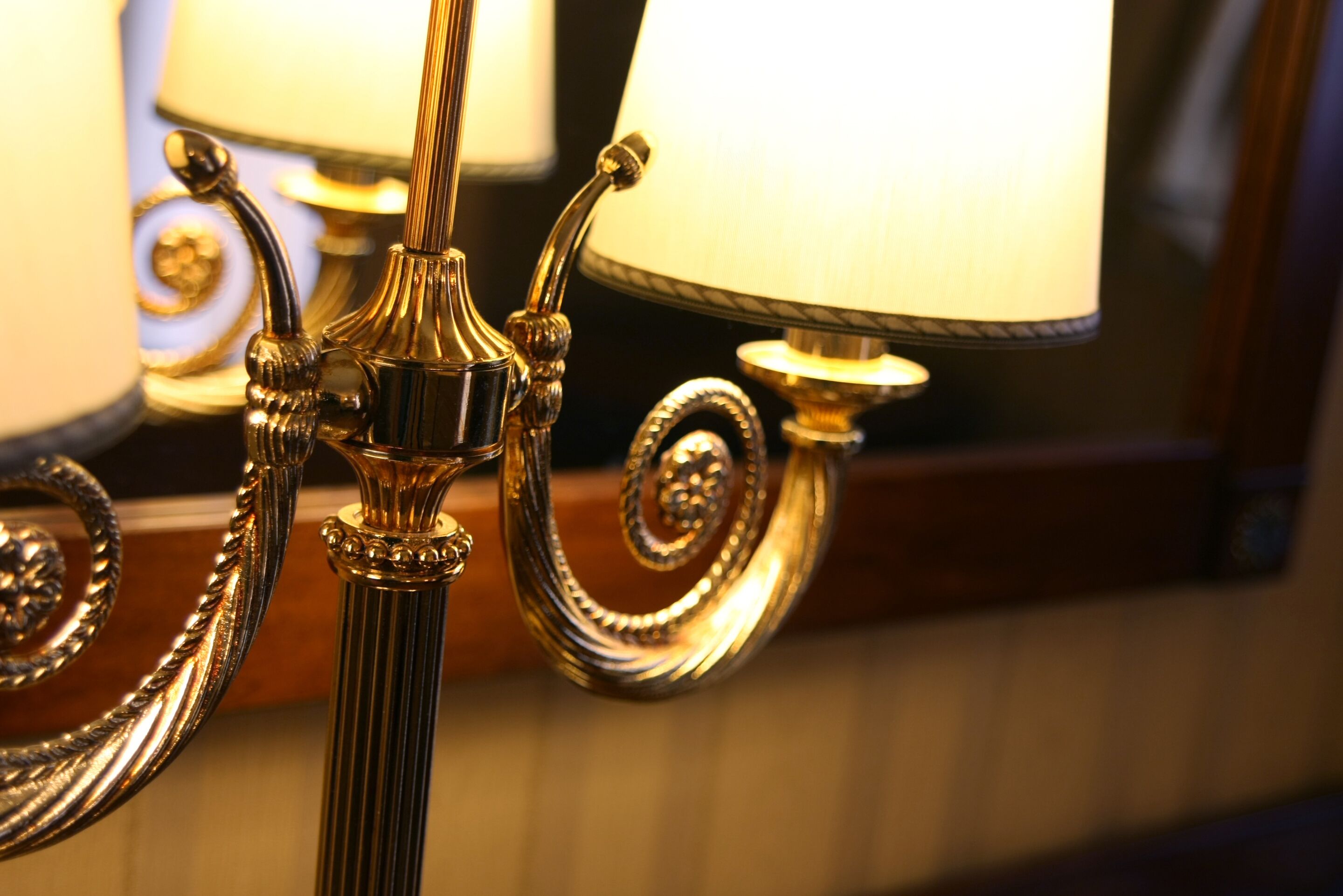 A close-up of a golden, ornate lamp with a spiral design.