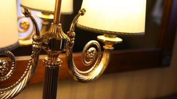 A close-up of a golden, ornate lamp with a spiral design.