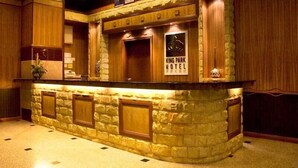 A reception area with a stone counter, framed pictures, and a sign for King Park Hotel. - King Park Hotel Kota Kinabalu (Kota Kinabalu)