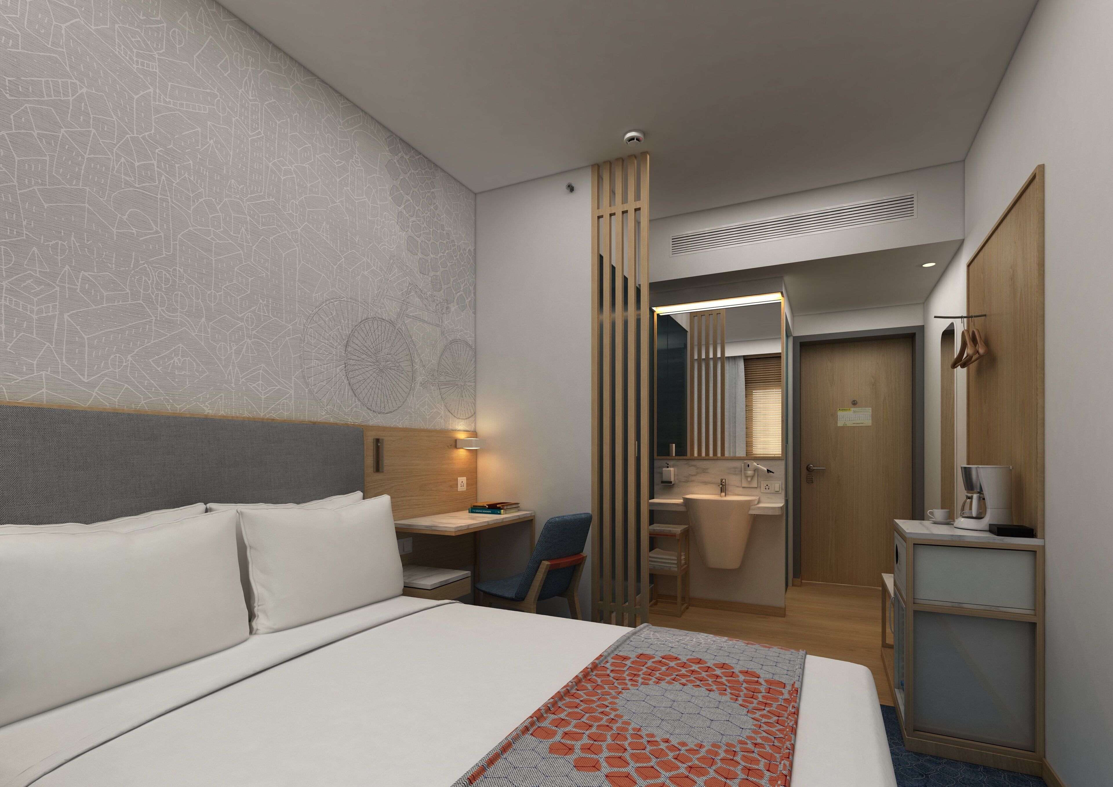 Ein modernes Hotelzimmer mit einem großen Bett, einem Schreibtisch, einem Stuhl, einem Badezimmer mit Waschbecken und Spiegel sowie einem Kleiderschrank.