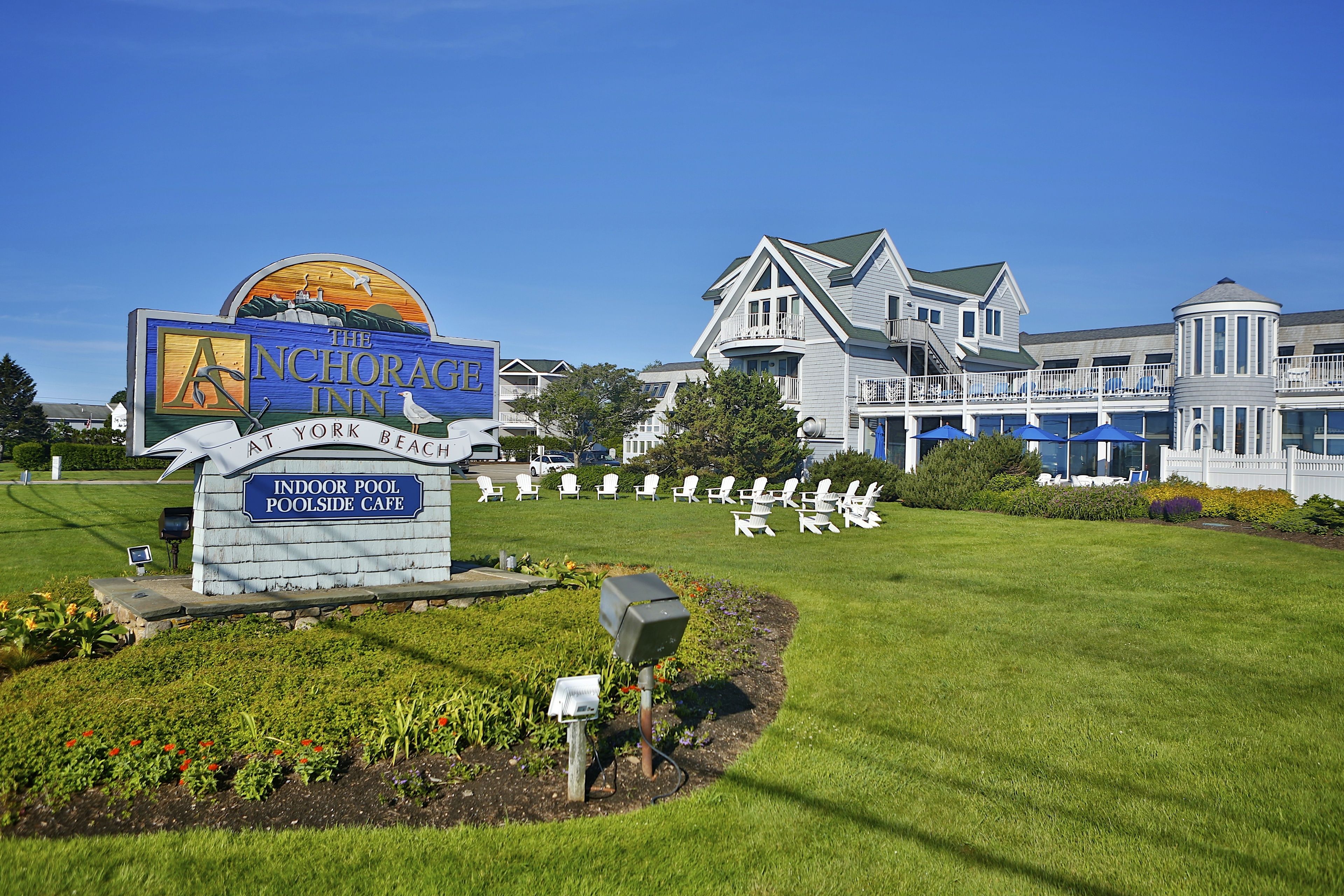 A hotel sign for The Anchorage Inn at York Beach with an indoor pool and a side cafe.