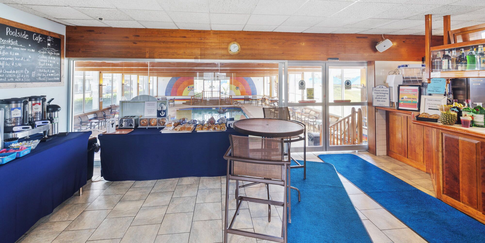 A poolside cafe with a buffet, bar, and outdoor seating area.